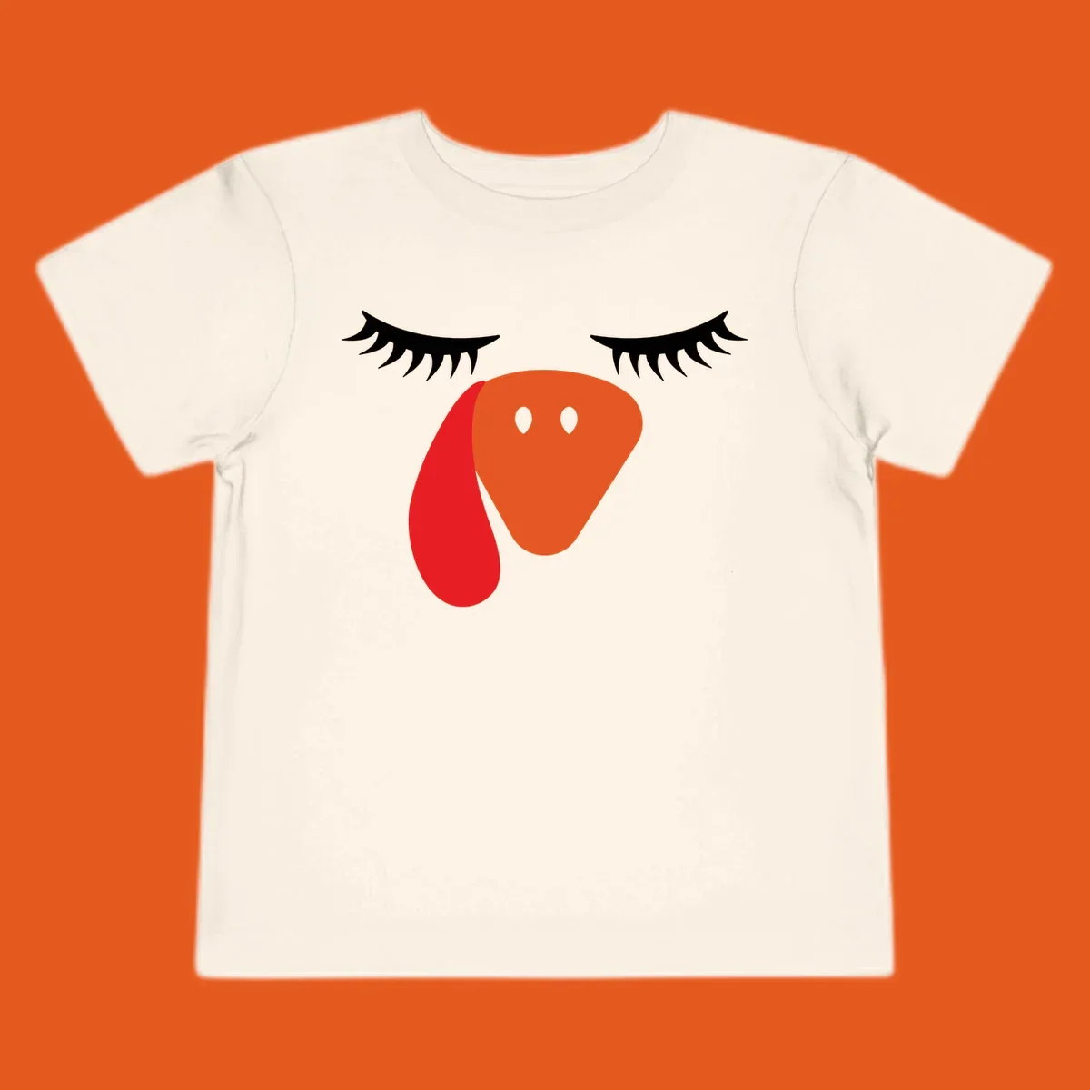Funny turkey face graphic with closed eyes and eyelashes, perfect for Turkey Trot shirts.