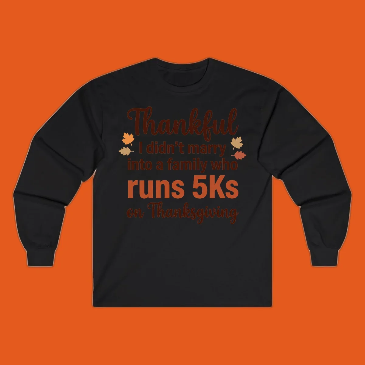 Text design 'Thankful I didn't marry into a family who runs 5Ks on Thanksgiving' with autumn leaves, for Thanksgiving 5k runner.