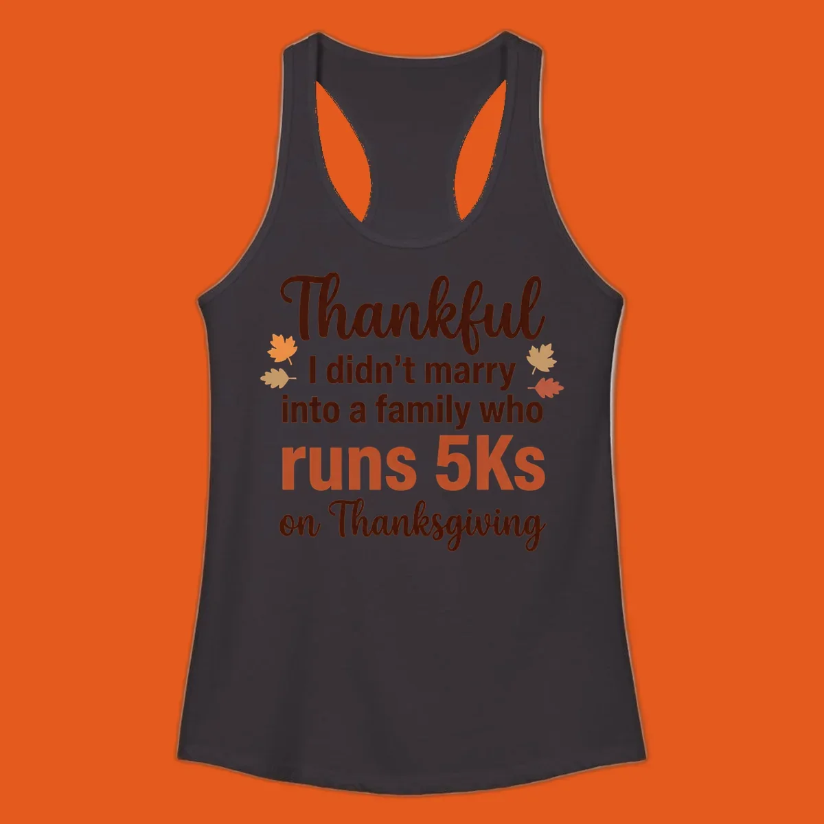 Text design 'Thankful I didn't marry into a family who runs 5Ks on Thanksgiving' with autumn leaves, for Thanksgiving 5k runner.