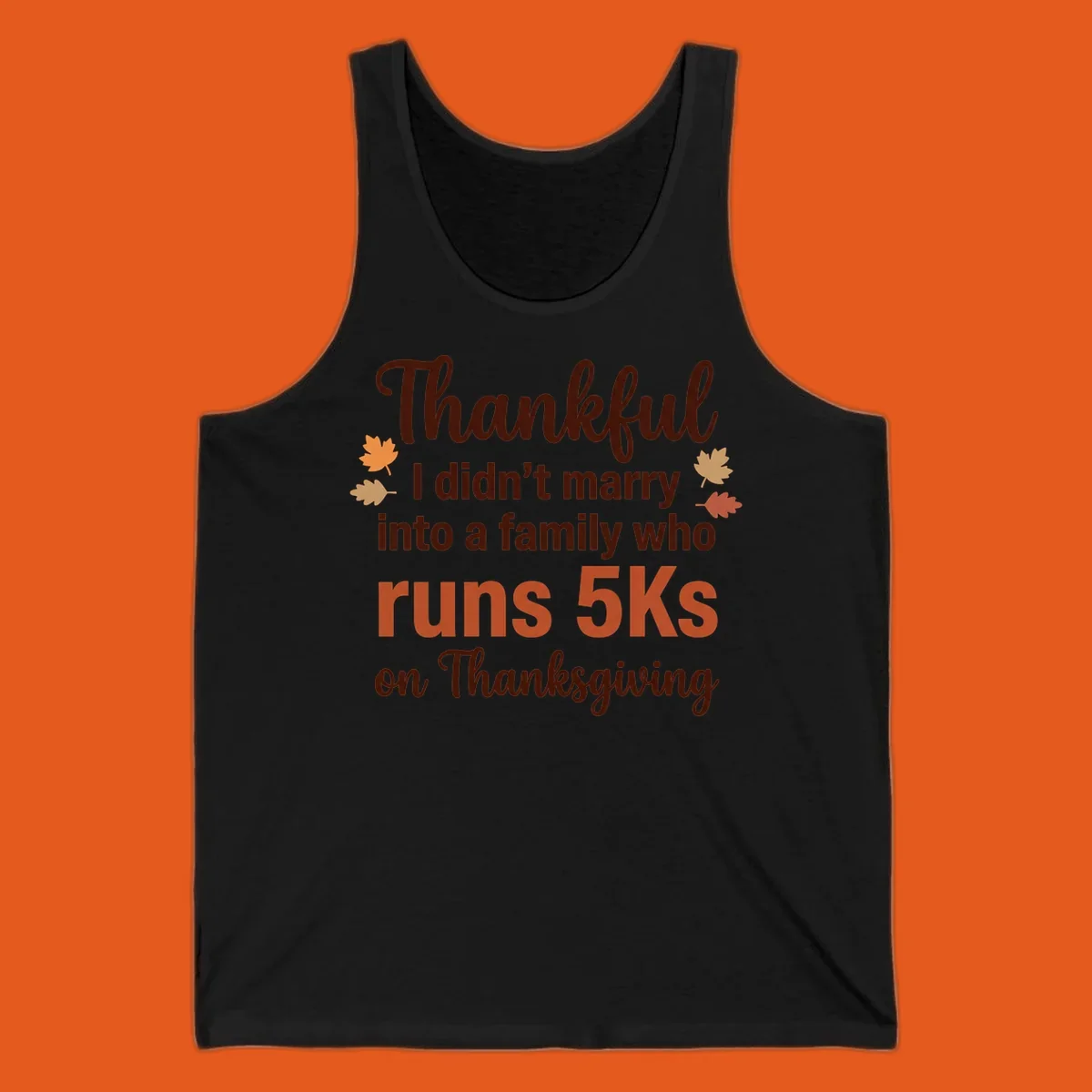 Text design 'Thankful I didn't marry into a family who runs 5Ks on Thanksgiving' with autumn leaves, for Thanksgiving 5k runner.
