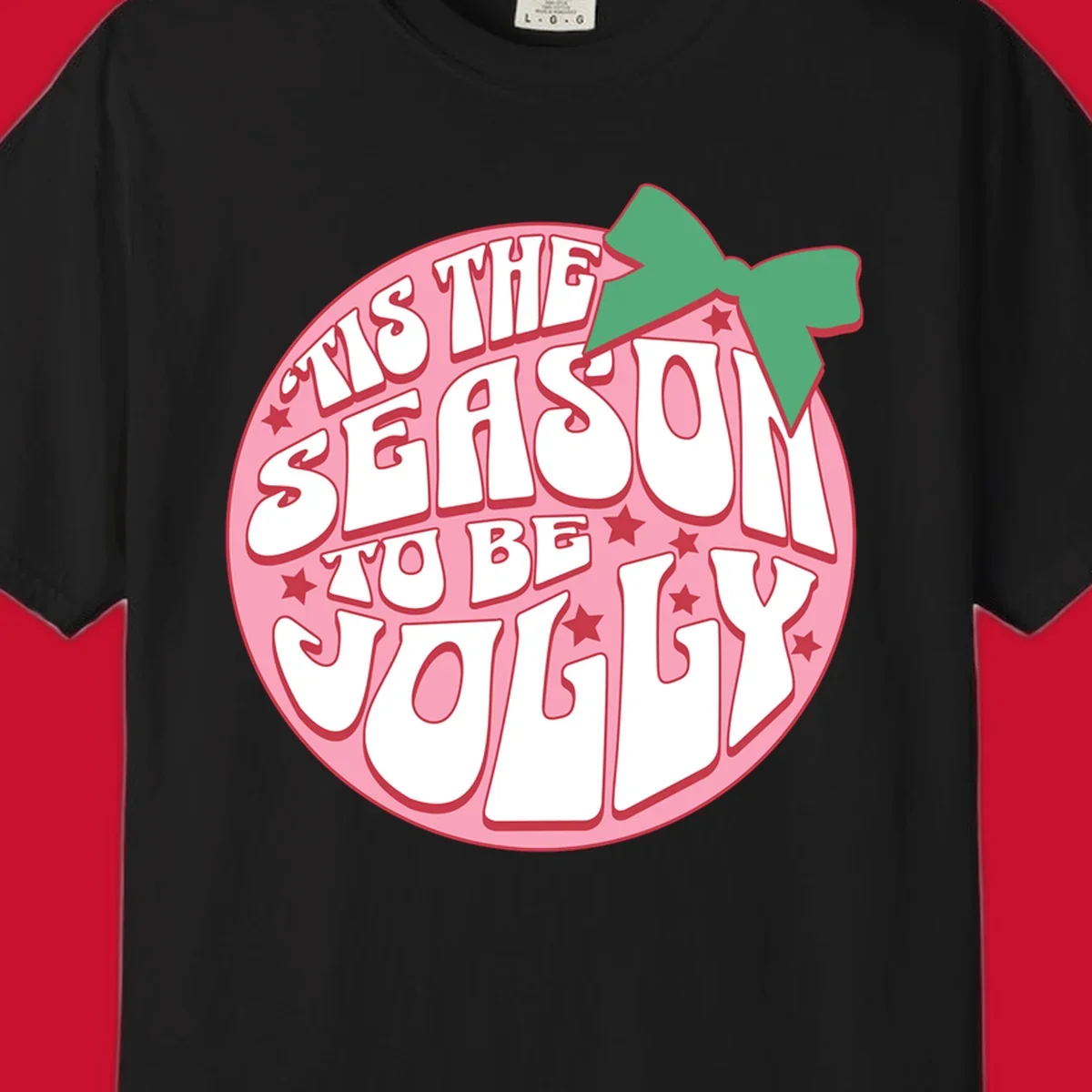 Tis the season to be jolly text with bow and stars, pink oval
