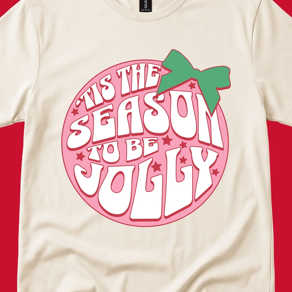 Tis the season to be jolly text with bow and stars, pink oval