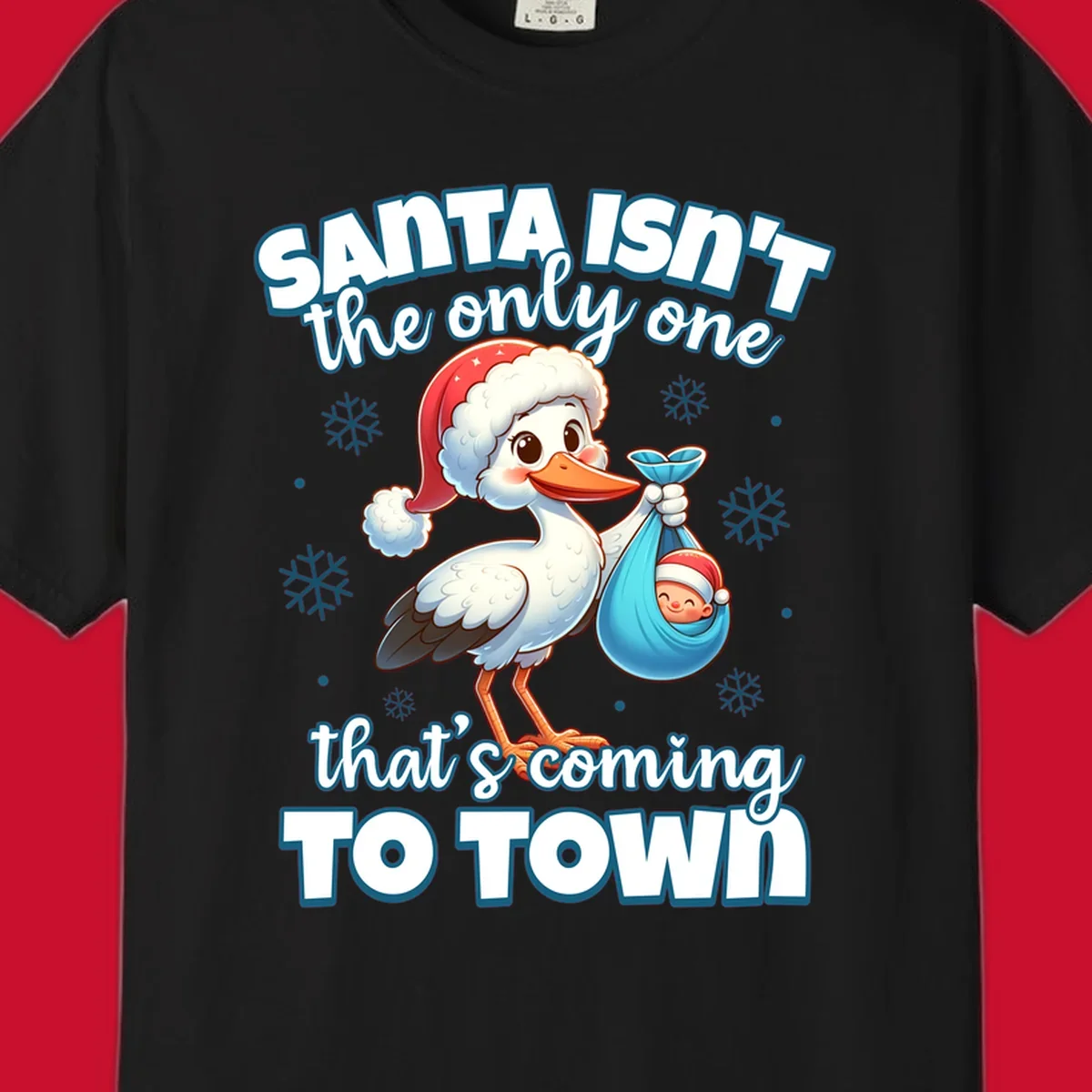 Stork carrying a baby with text "Santa Isn't The Only One That's Coming To Town".