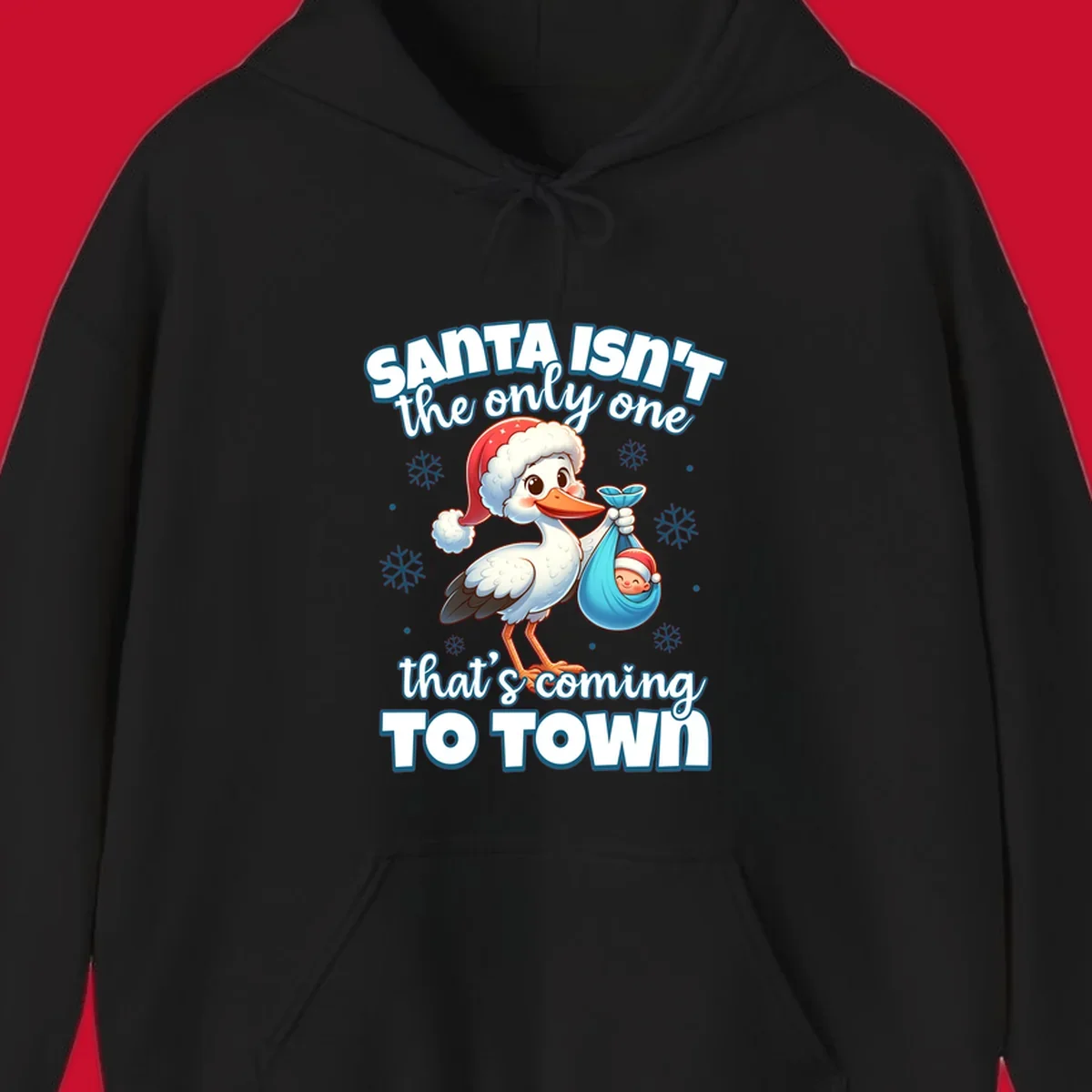 Stork carrying a baby with text "Santa Isn't The Only One That's Coming To Town".