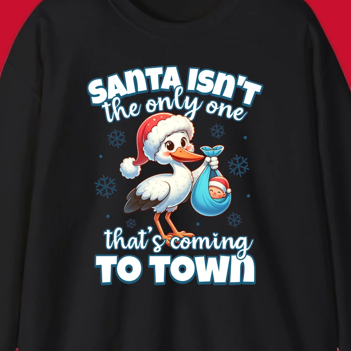 Stork carrying a baby with text "Santa Isn't The Only One That's Coming To Town".