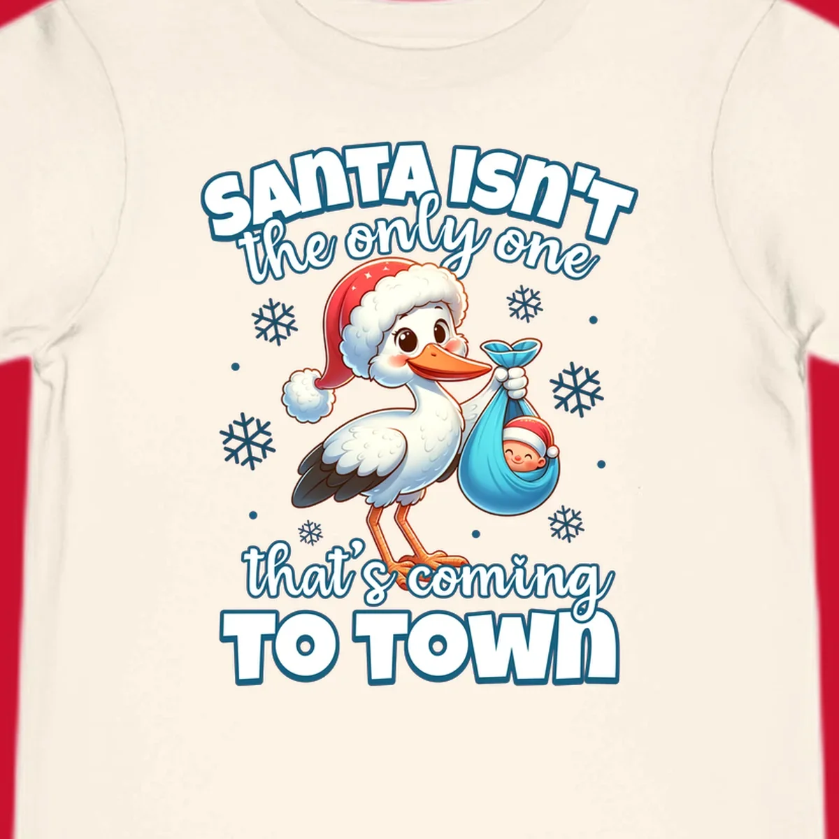 Stork carrying a baby with text "Santa Isn't The Only One That's Coming To Town".