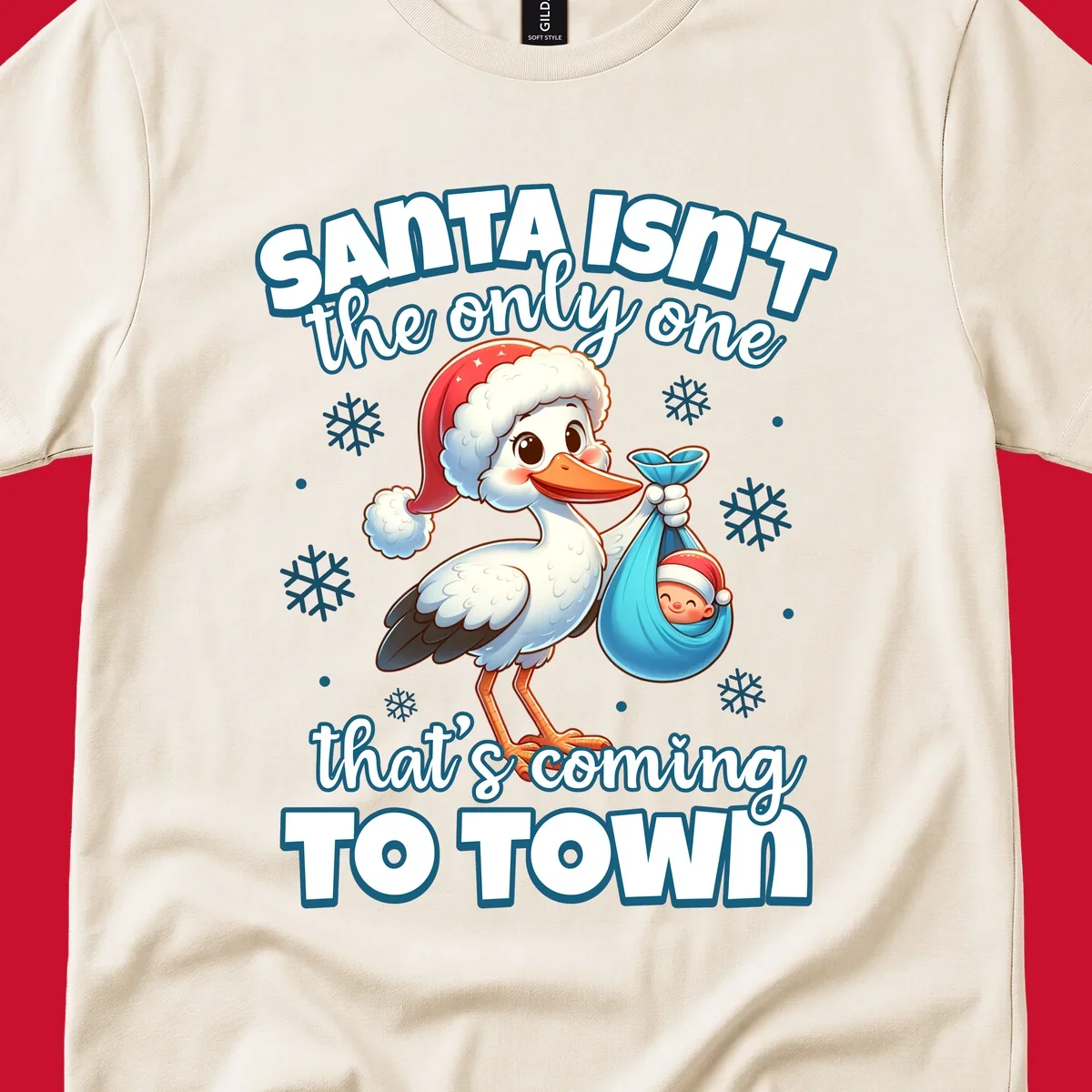 Stork carrying a baby with text "Santa Isn't The Only One That's Coming To Town".