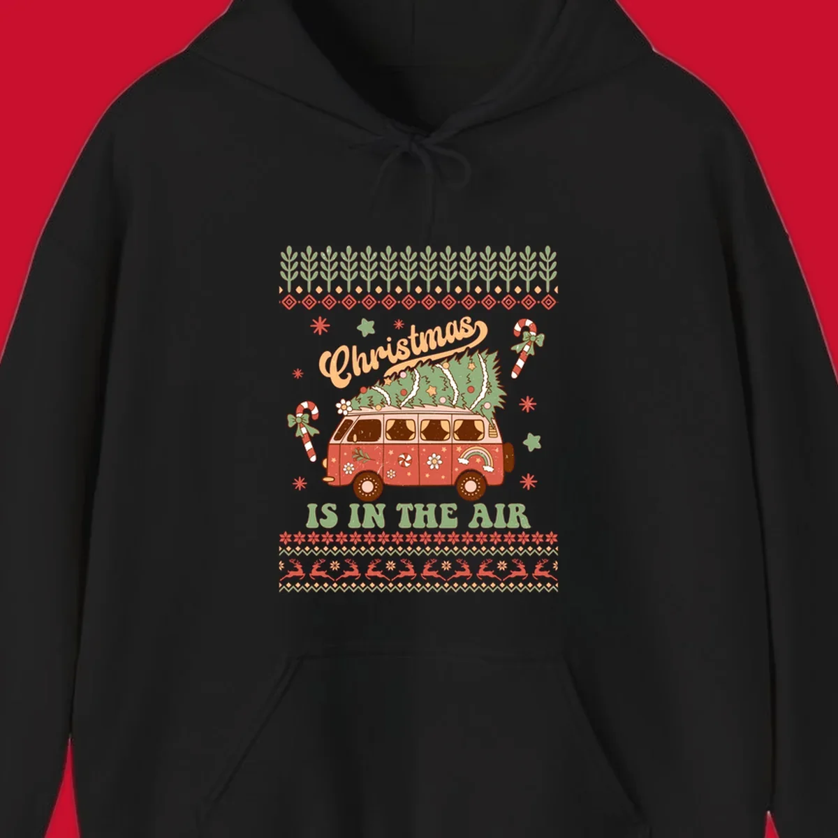 Retro Christmas van with tree on roof and 'Christmas IS IN THE AIR' text.