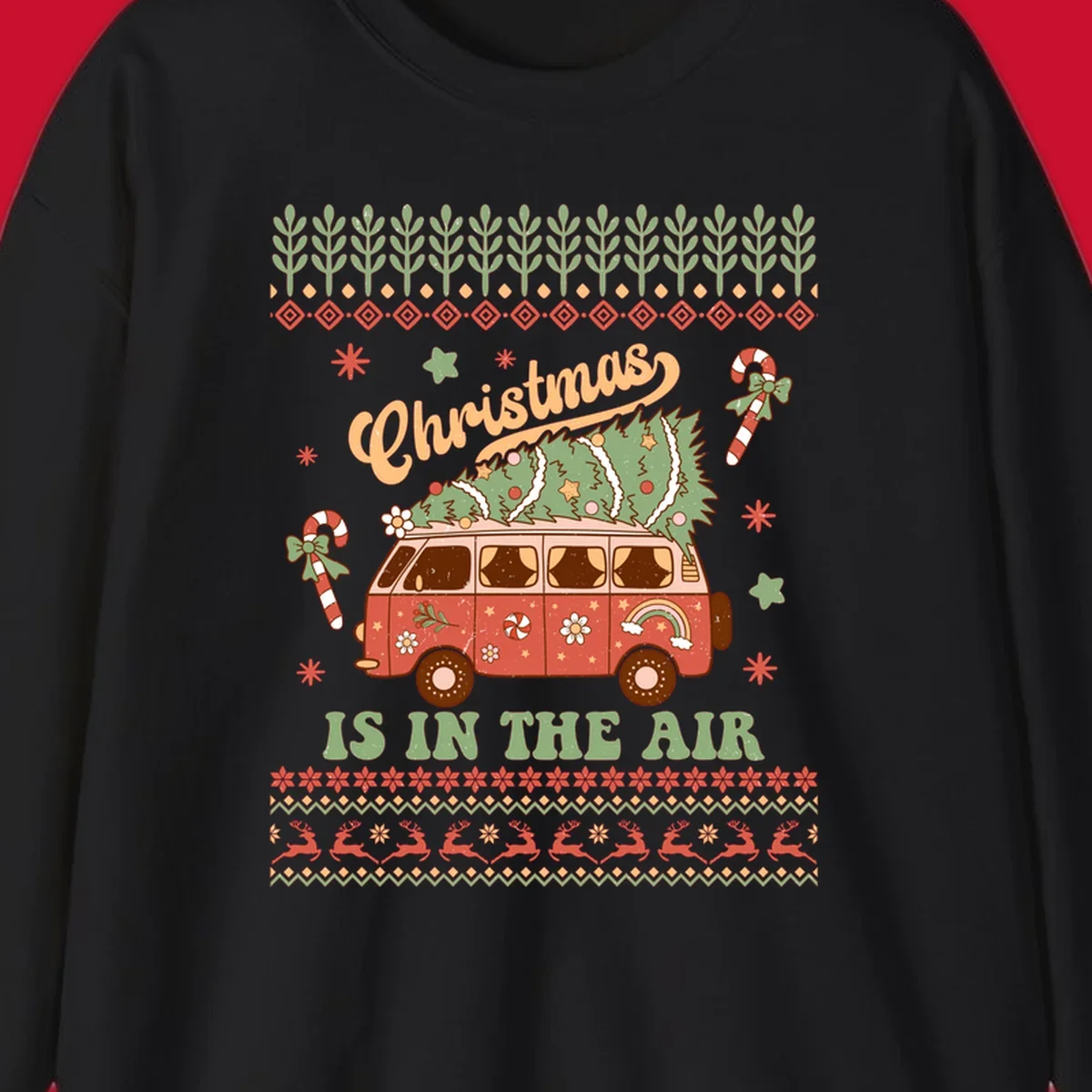 Retro Christmas van with tree on roof and 'Christmas IS IN THE AIR' text.