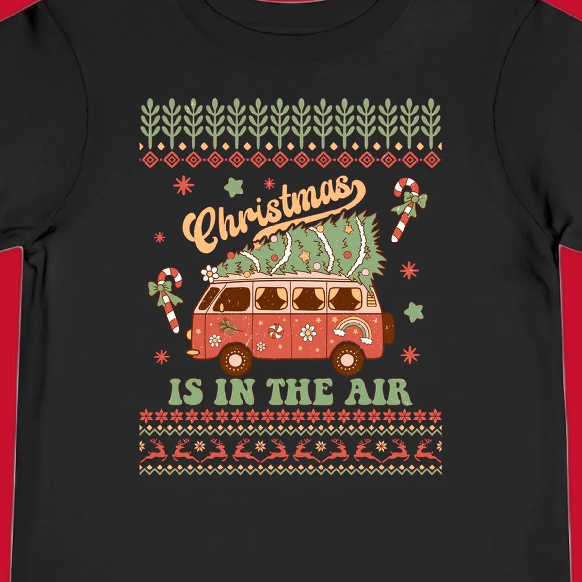 Retro Christmas van with tree on roof and 'Christmas IS IN THE AIR' text.