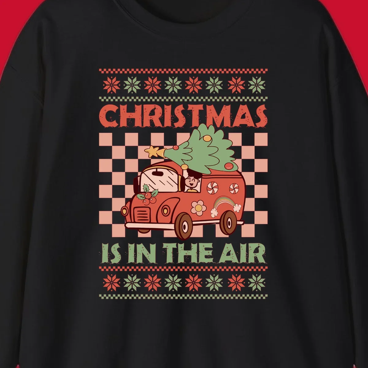 Christmas van with tree on top, text 'Christmas Is In The Air', snowflake borders, checkered pattern.