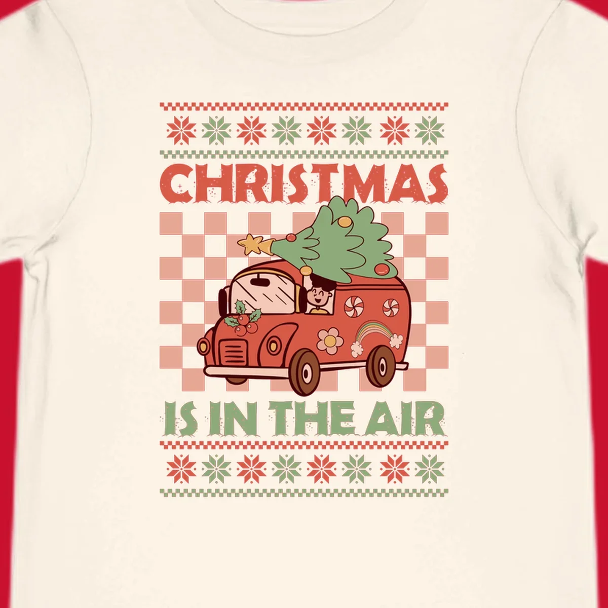 Christmas van with tree on top, text 'Christmas Is In The Air', snowflake borders, checkered pattern.