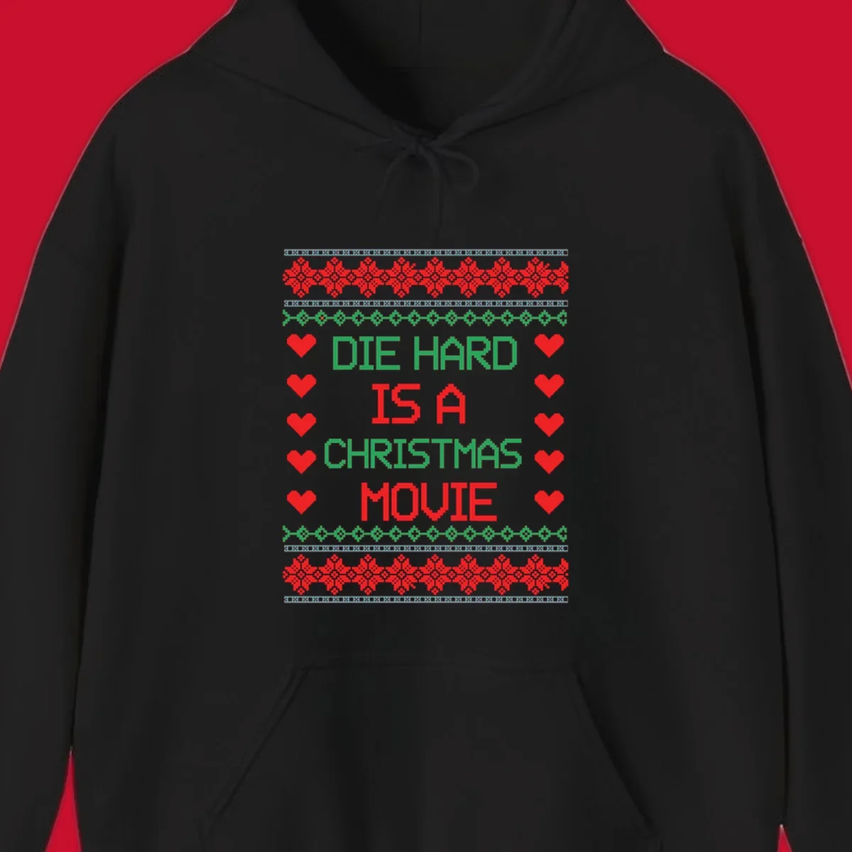 Die Hard is a Christmas Movie pixel art design with red hearts and holiday patterns.