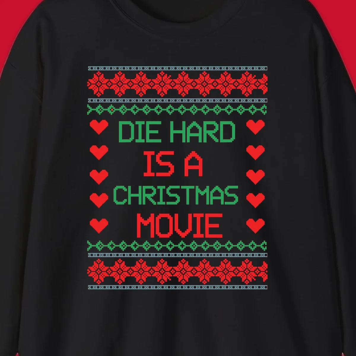 Die Hard is a Christmas Movie pixel art design with red hearts and holiday patterns.