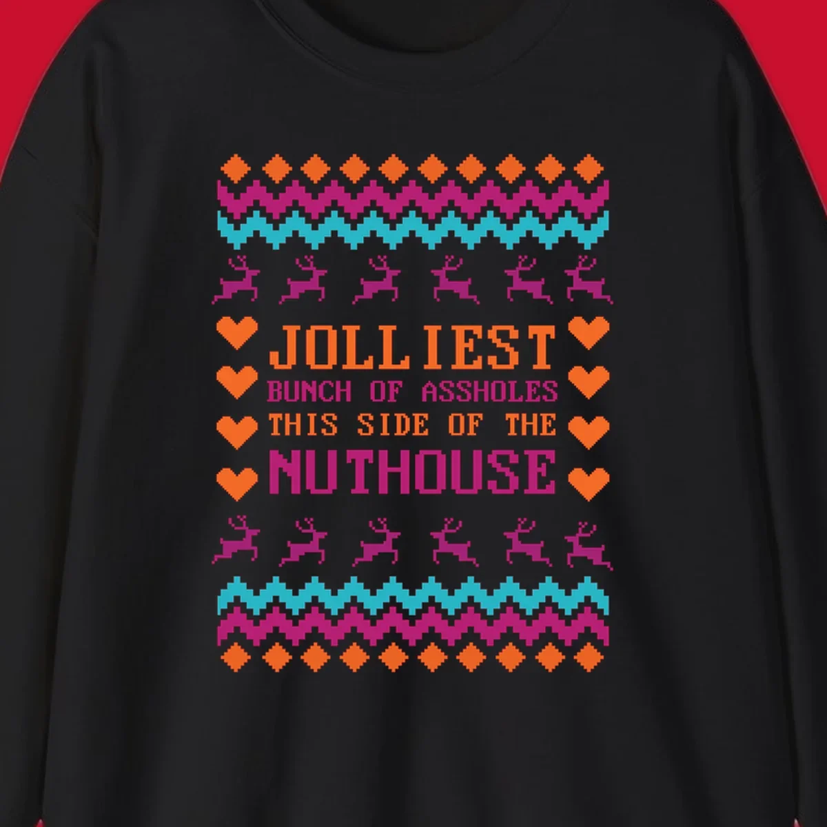 Jolliiest Bunch Of Assholes text with reindeer and heart graphics in an ugly sweater pattern.