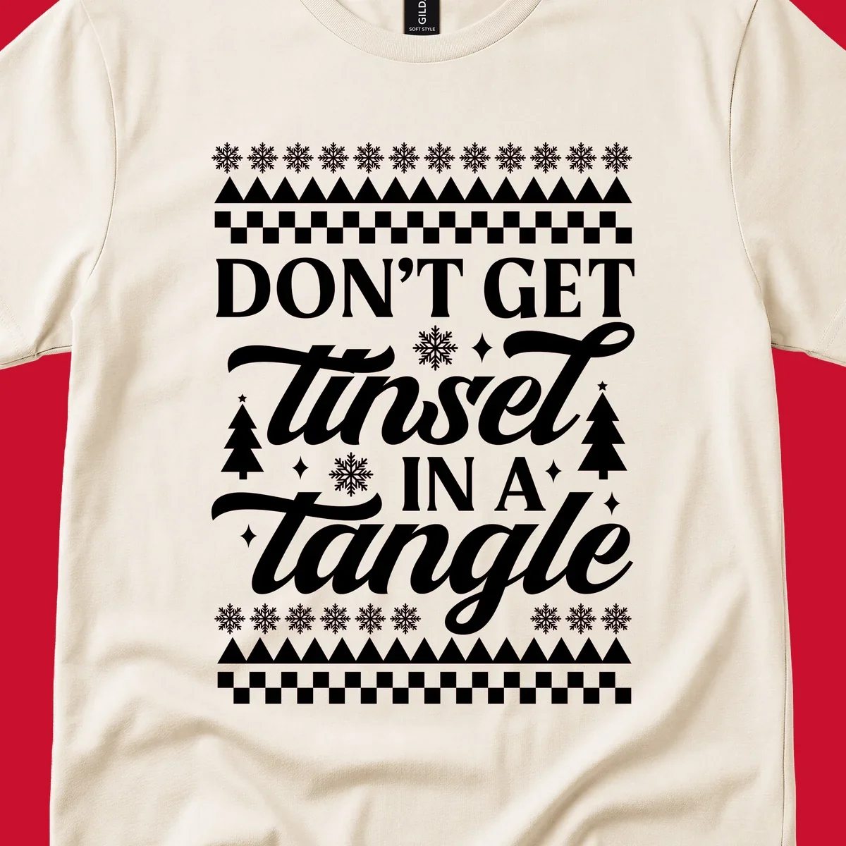 Don't Get Tinsel In A Tangle holiday design with snowflakes and trees.