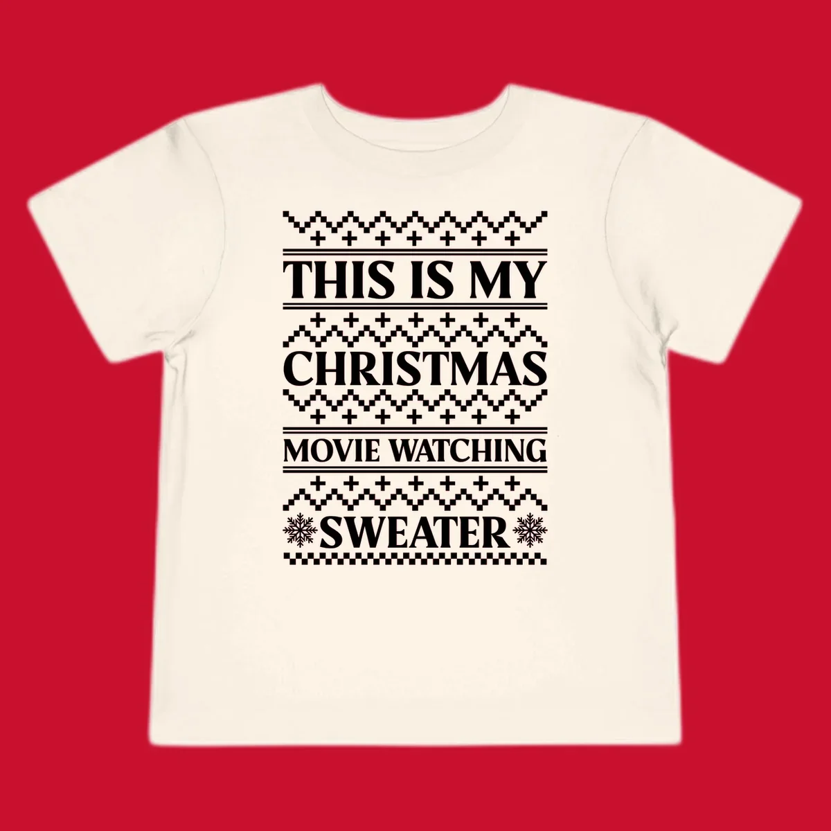 Christmas movie watching sweater with bold text and festive patterns.