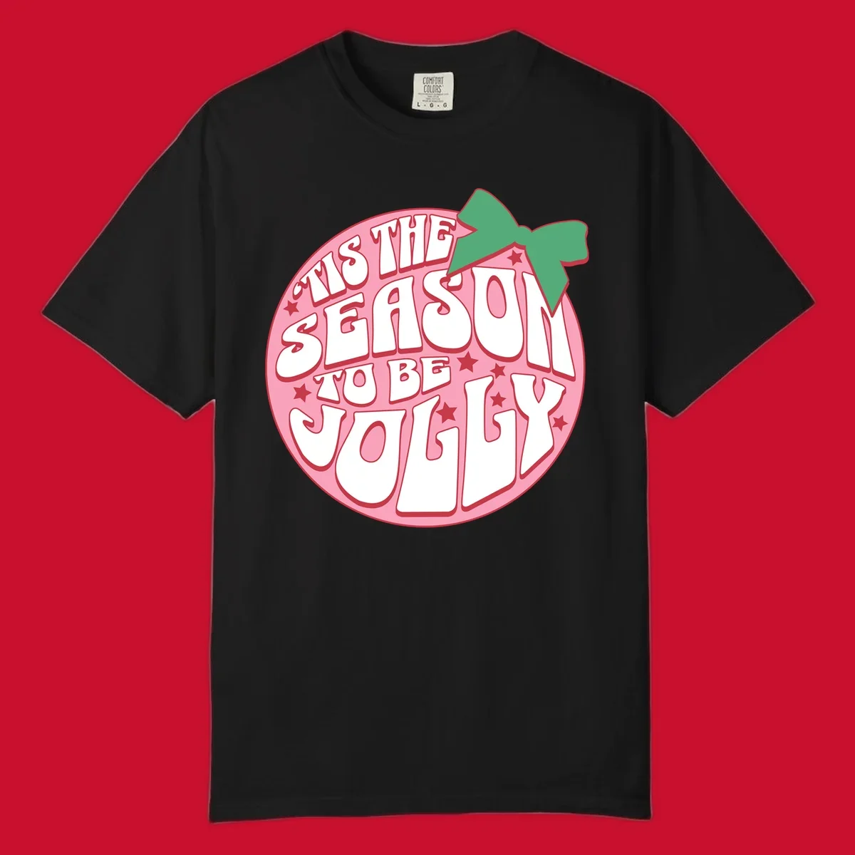 Tis the season to be jolly text with bow and stars, pink oval