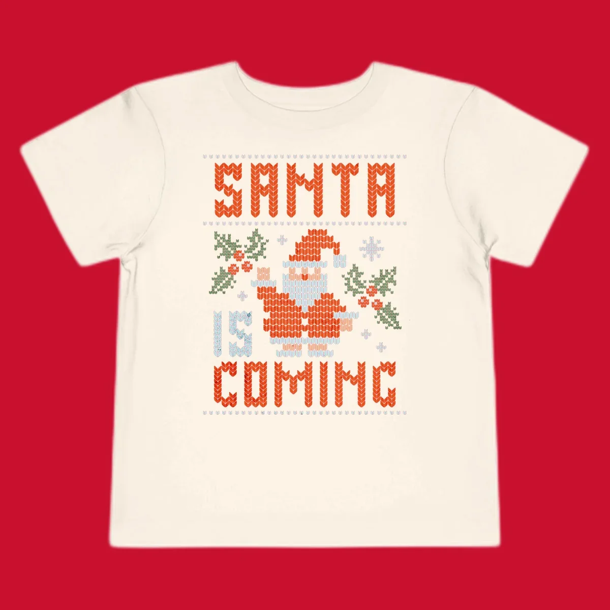 Santa is coming ugly Christmas sweater with pixelated Santa, holly, and snowflakes.