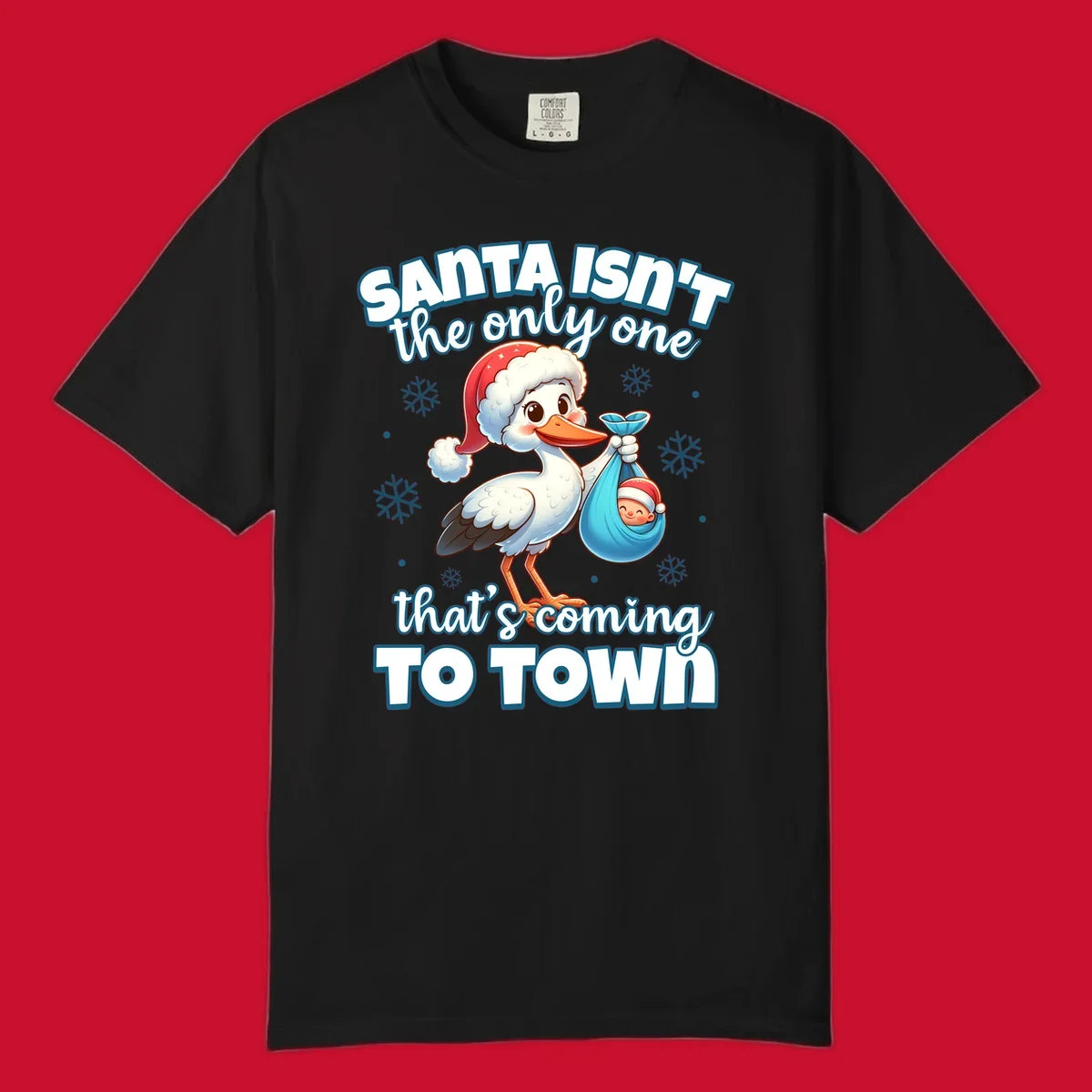 Stork carrying a baby with text "Santa Isn't The Only One That's Coming To Town".