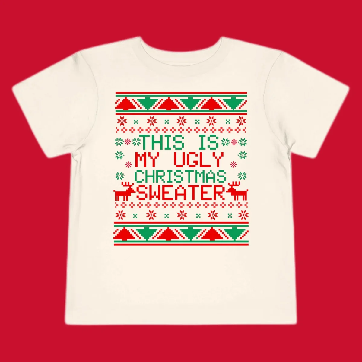 Ugly Christmas sweater statement design with pixelated text, reindeer, and snowflakes.