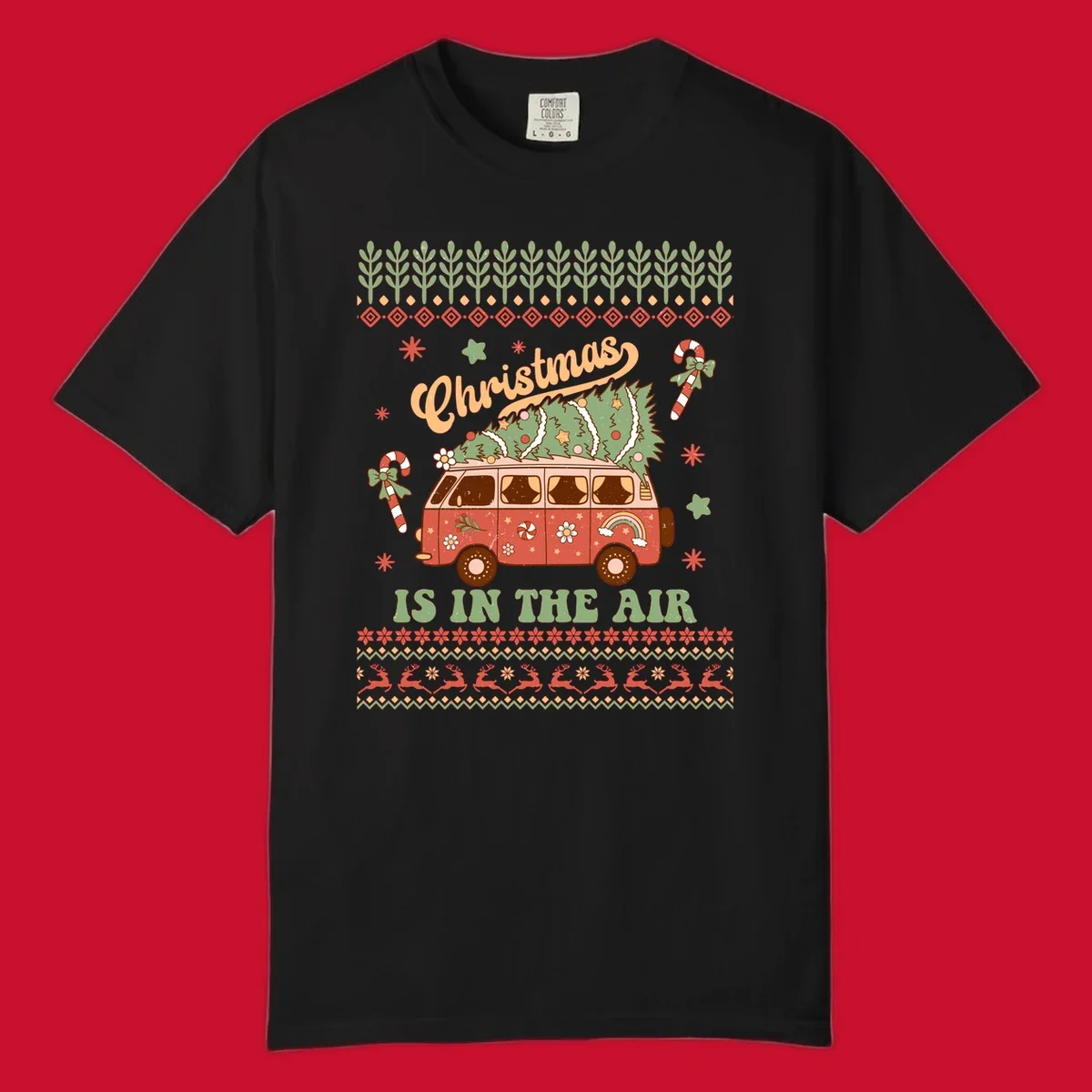 Retro Christmas van with tree on roof and 'Christmas IS IN THE AIR' text.