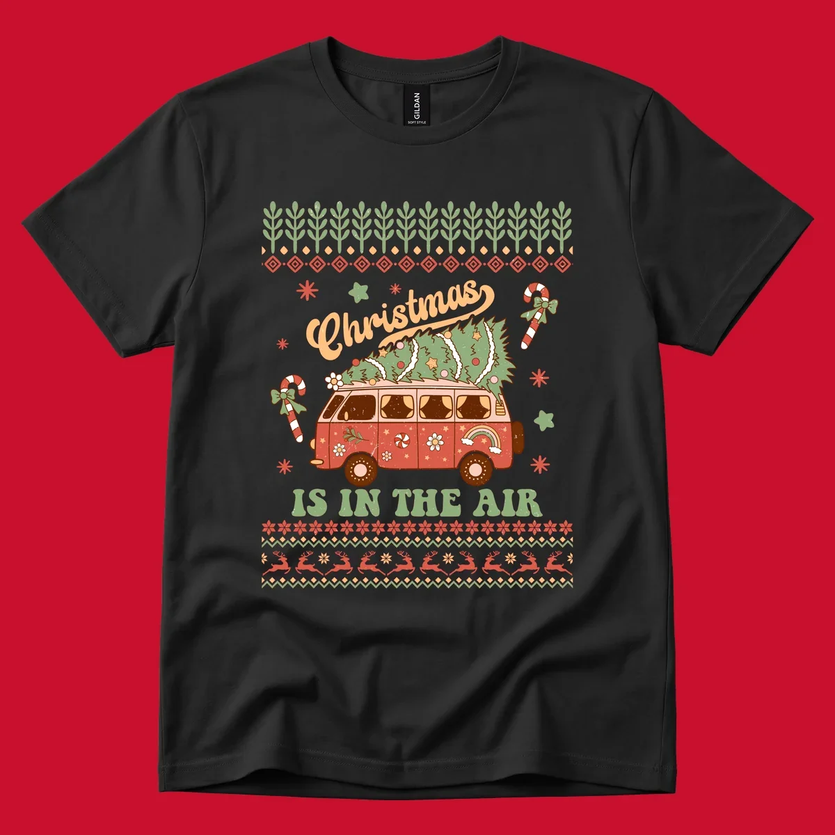 Retro Christmas van with tree on roof and 'Christmas IS IN THE AIR' text.
