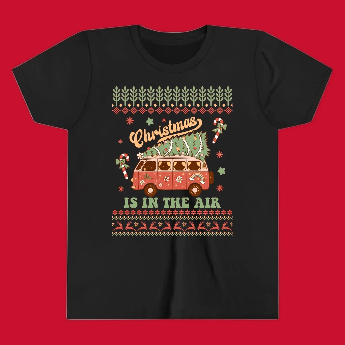 Retro Christmas van with tree on roof and 'Christmas IS IN THE AIR' text.