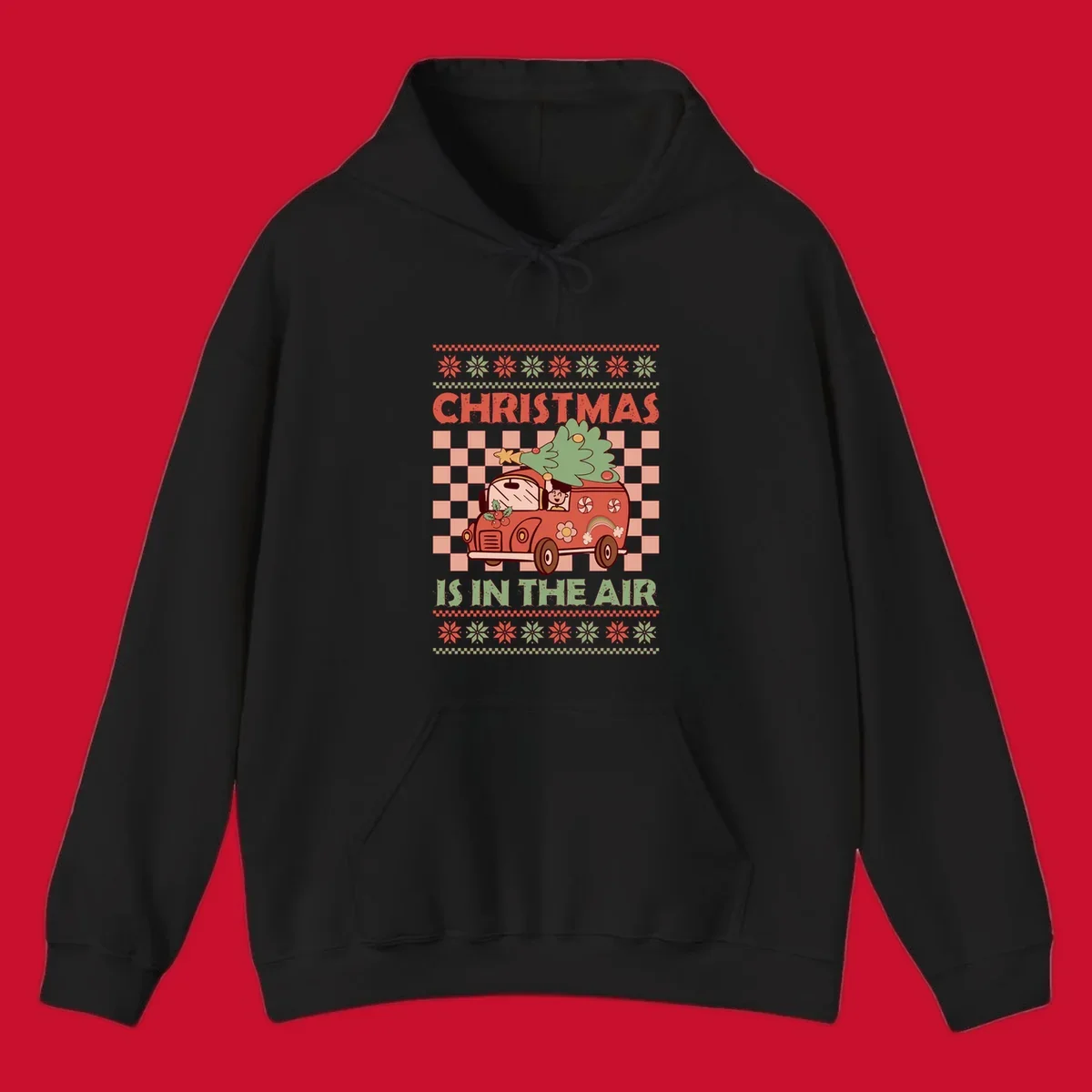 Christmas van with tree on top, text 'Christmas Is In The Air', snowflake borders, checkered pattern.