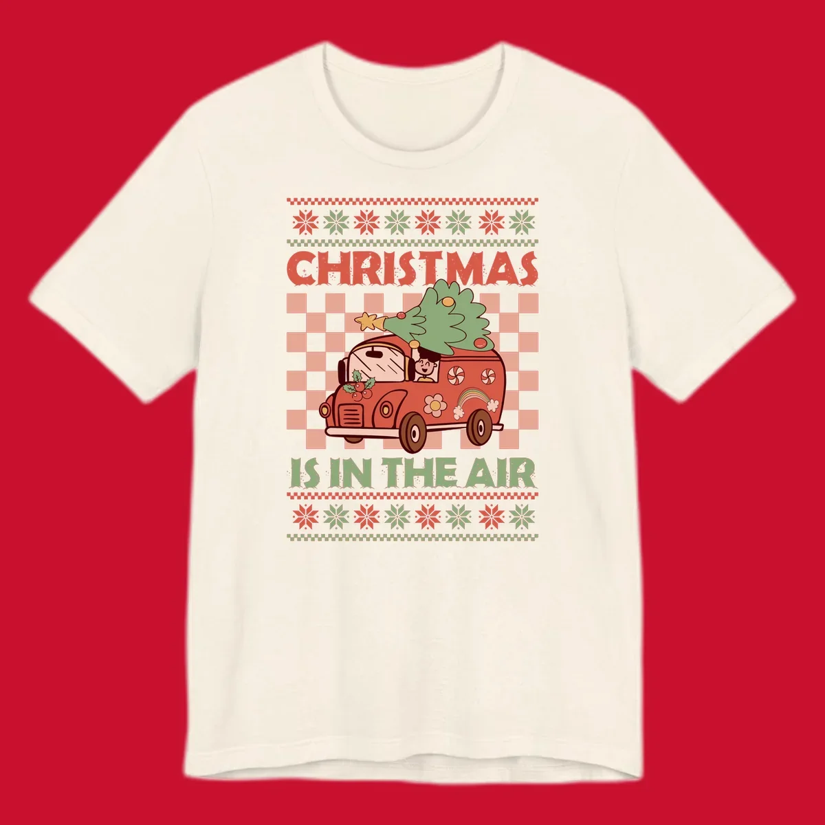 Christmas van with tree on top, text 'Christmas Is In The Air', snowflake borders, checkered pattern.