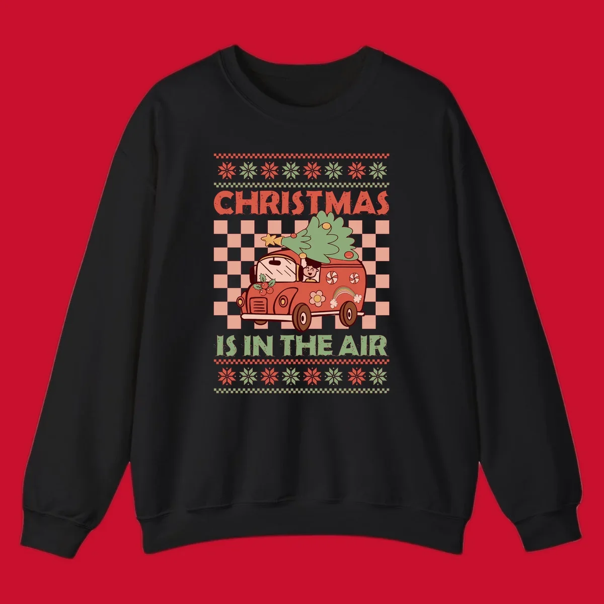 Christmas van with tree on top, text 'Christmas Is In The Air', snowflake borders, checkered pattern.