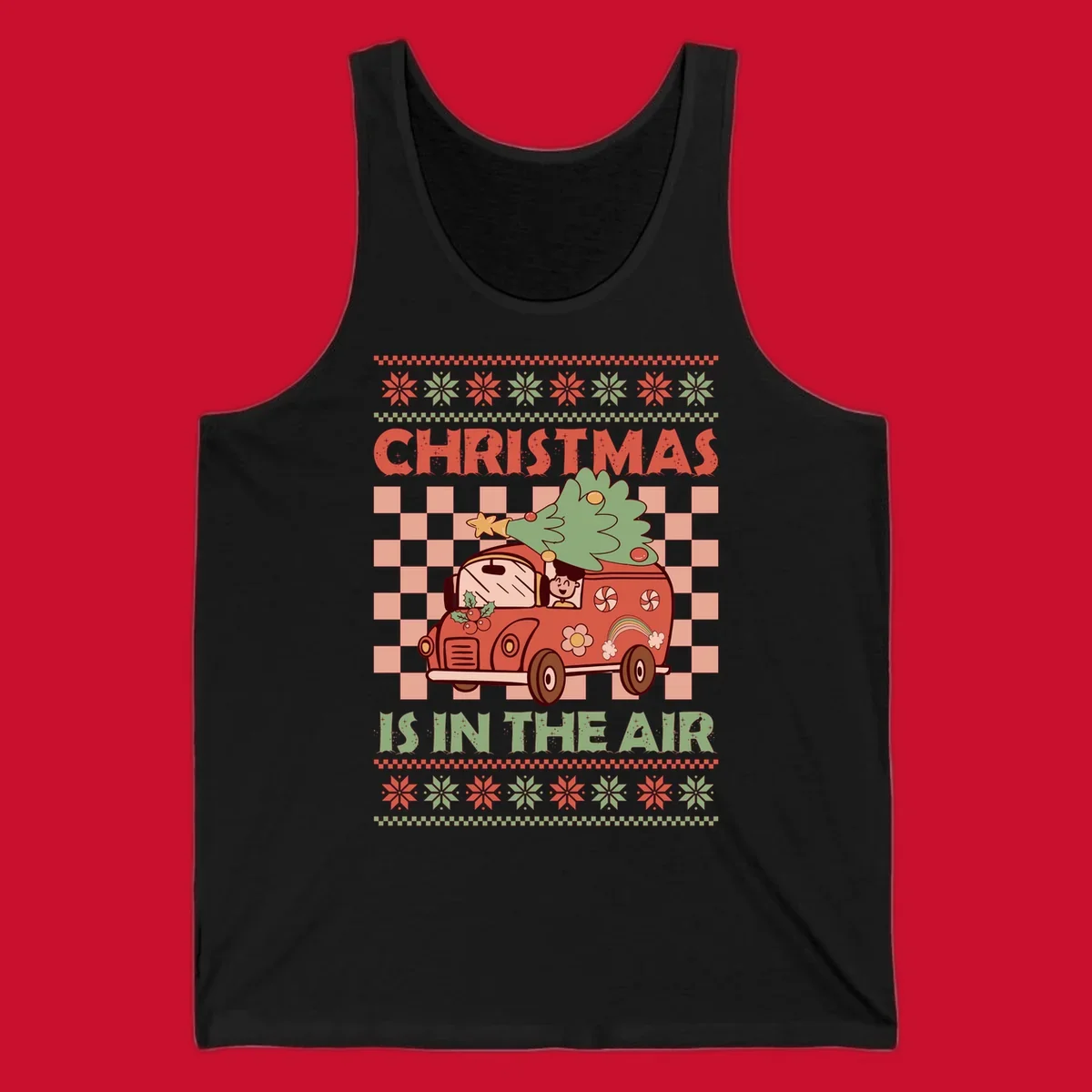 Christmas van with tree on top, text 'Christmas Is In The Air', snowflake borders, checkered pattern.