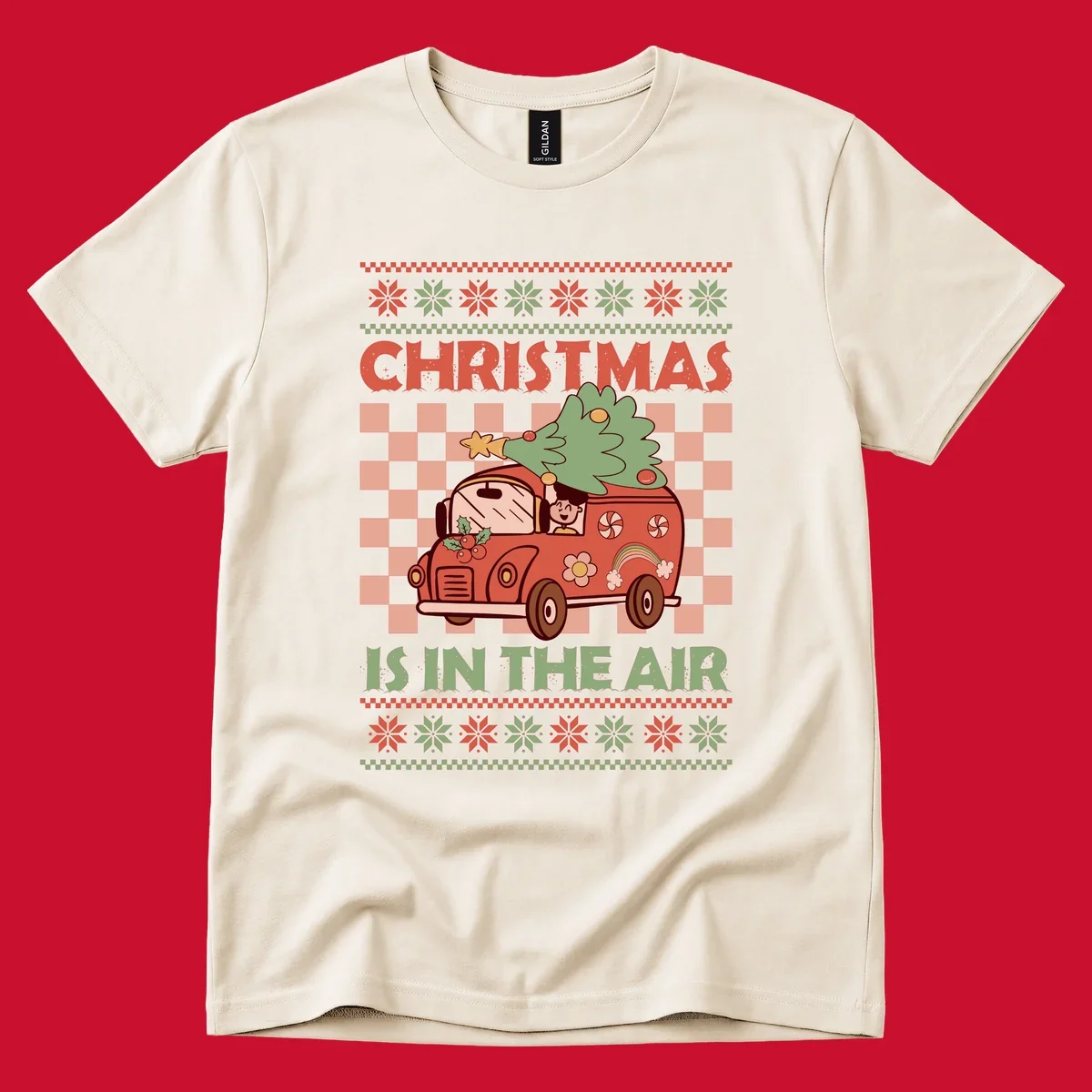 Christmas van with tree on top, text 'Christmas Is In The Air', snowflake borders, checkered pattern.