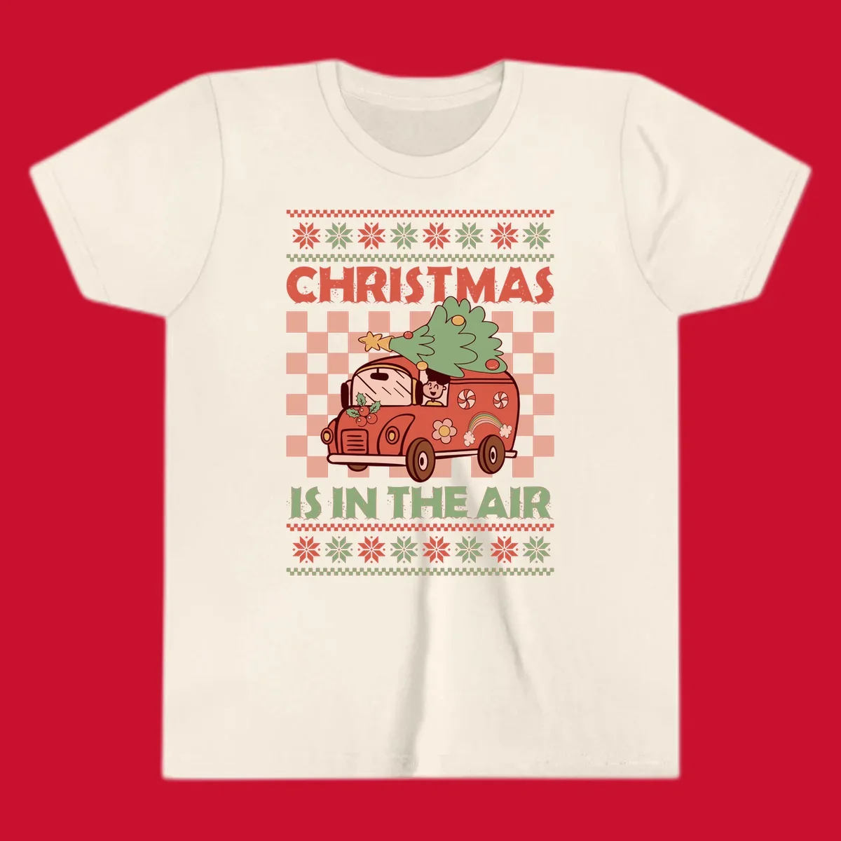 Christmas van with tree on top, text 'Christmas Is In The Air', snowflake borders, checkered pattern.
