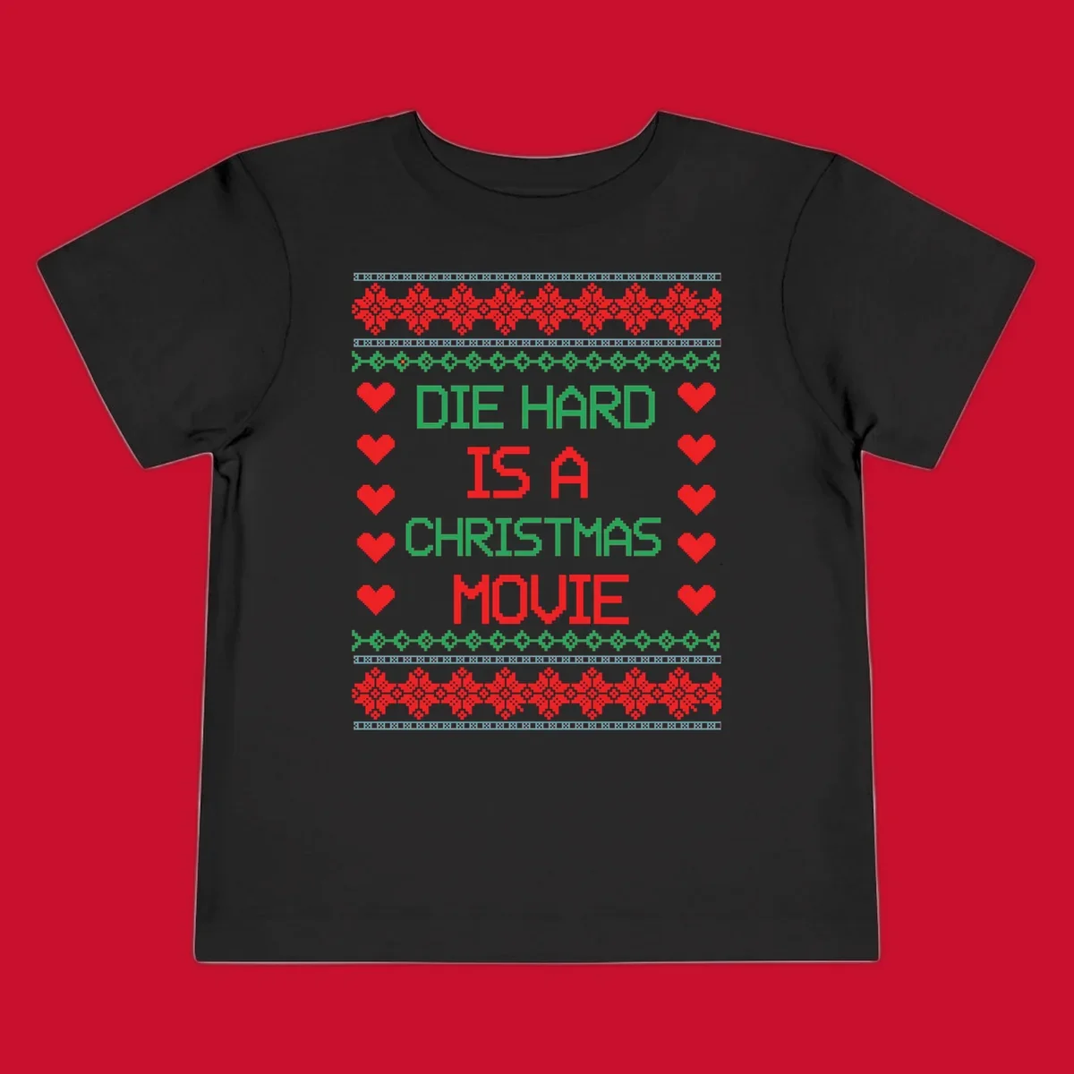 Die Hard is a Christmas Movie pixel art design with red hearts and holiday patterns.