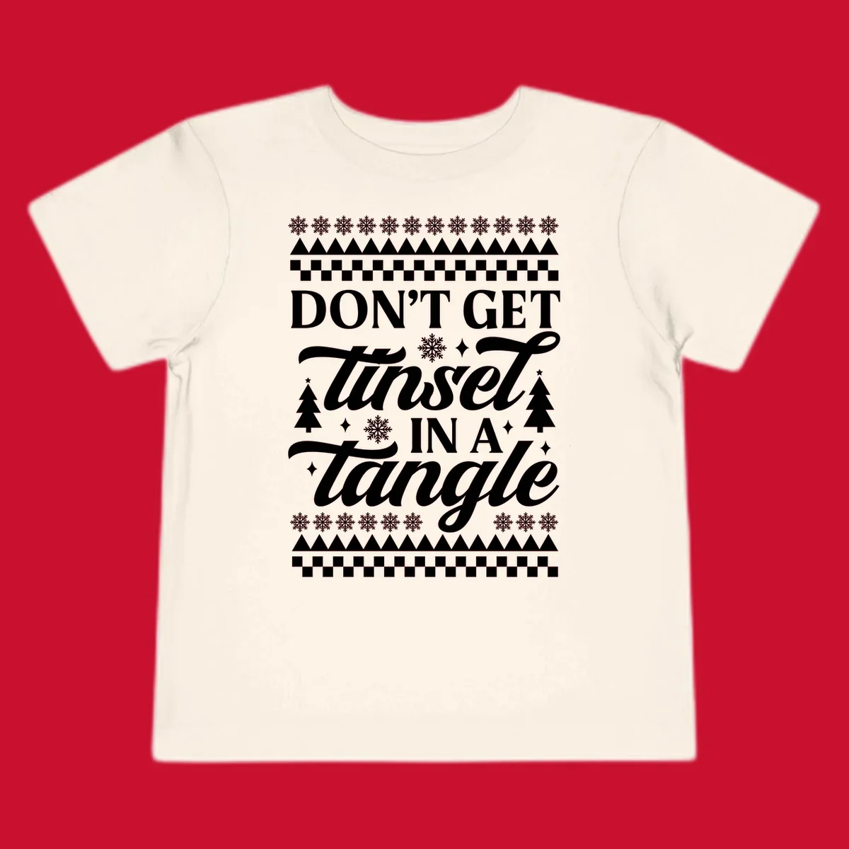 Don't Get Tinsel In A Tangle holiday design with snowflakes and trees.